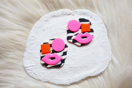 Avant-Garde Polymer Clay Abstract Faces Earrings: Black & White Checkered Background with Vibrant Pink and Orange Details- Unique polymer clay Studs